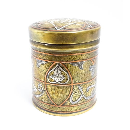 1070 - An early 20thC Middle Eastern brass pot and cover with engraved detail and inlaid white metal and co... 