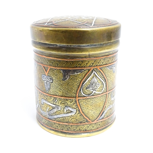 1070 - An early 20thC Middle Eastern brass pot and cover with engraved detail and inlaid white metal and co... 