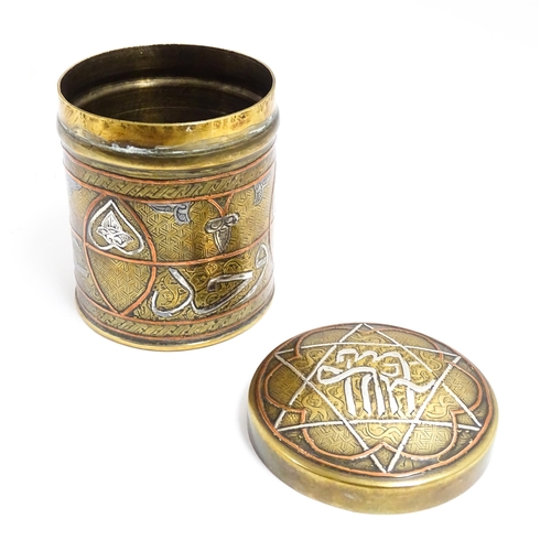 1070 - An early 20thC Middle Eastern brass pot and cover with engraved detail and inlaid white metal and co... 