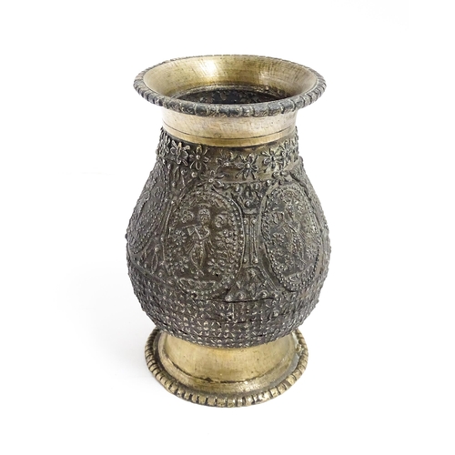 1072 - An Indian brass vase with banded figural and floral detail. Approx. 4 1/2