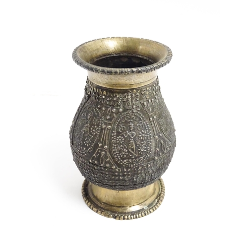 1072 - An Indian brass vase with banded figural and floral detail. Approx. 4 1/2