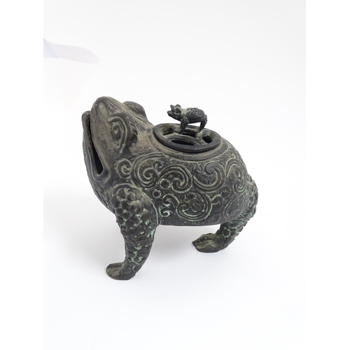 1078 - A Chinese cast censer modelled as a three legged toad with scrolling decoration, the pierced lid wit... 