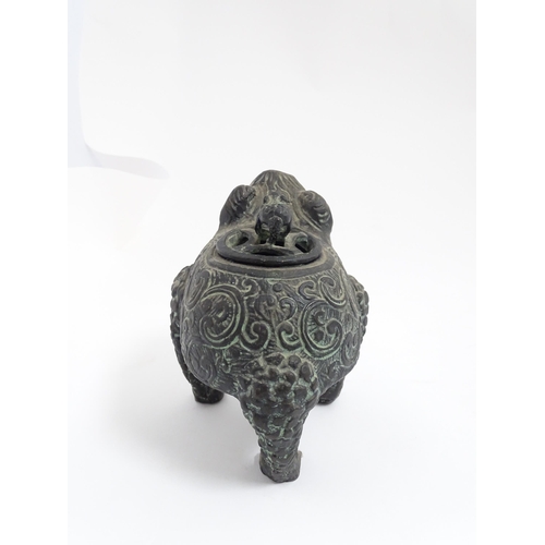 1078 - A Chinese cast censer modelled as a three legged toad with scrolling decoration, the pierced lid wit... 