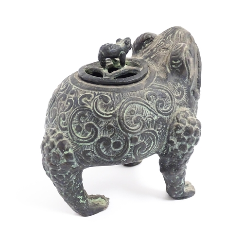 1078 - A Chinese cast censer modelled as a three legged toad with scrolling decoration, the pierced lid wit... 