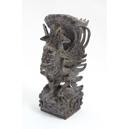 1080 - A Balinese hardwood carving depicting Vishnu riding Garuda. Approx. 10 1/2