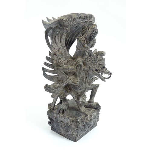 1080 - A Balinese hardwood carving depicting Vishnu riding Garuda. Approx. 10 1/2