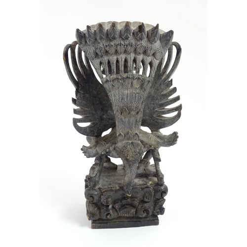 1080 - A Balinese hardwood carving depicting Vishnu riding Garuda. Approx. 10 1/2