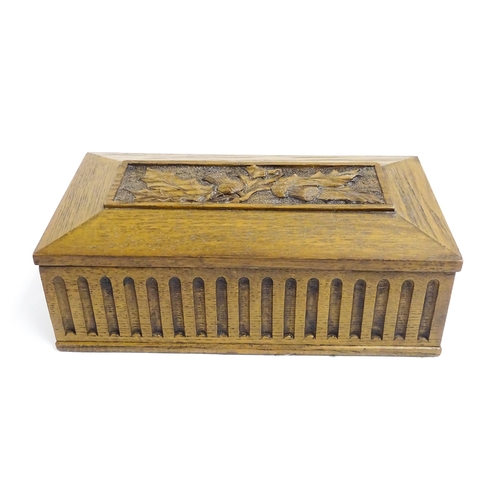 1086 - A 20thC oak box of rectangular form with carved thistle detail. Approx. 3 1/2