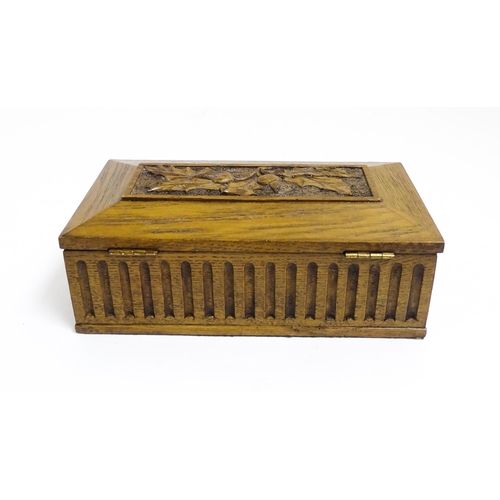 1086 - A 20thC oak box of rectangular form with carved thistle detail. Approx. 3 1/2