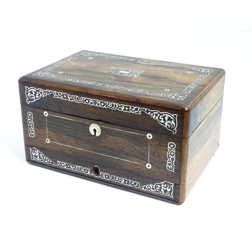 1087 - A Victorian rosewood workbox with drawer under, the exterior decorated with mother of pearl inlay. A... 