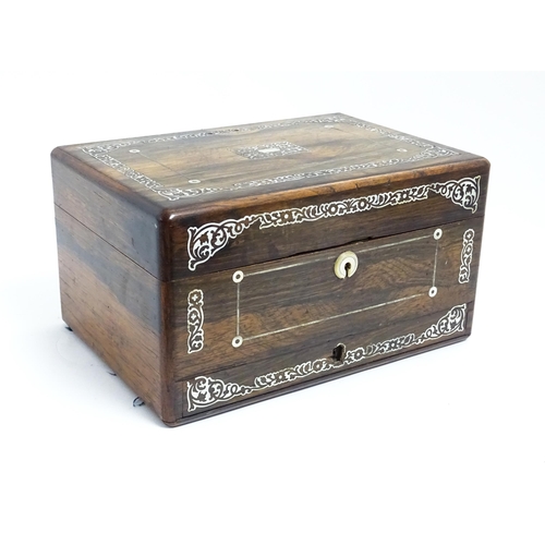 1087 - A Victorian rosewood workbox with drawer under, the exterior decorated with mother of pearl inlay. A... 