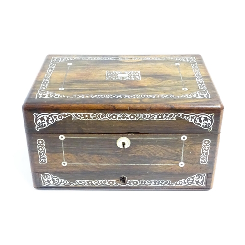 1087 - A Victorian rosewood workbox with drawer under, the exterior decorated with mother of pearl inlay. A... 