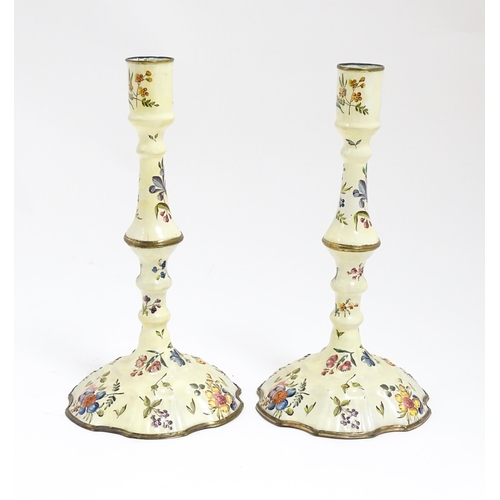 1088 - Two Bilston / Battersea enamel candlesticks with knopped columns and domed bases with hand painted f... 