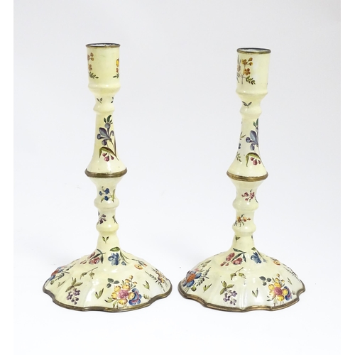 1088 - Two Bilston / Battersea enamel candlesticks with knopped columns and domed bases with hand painted f... 