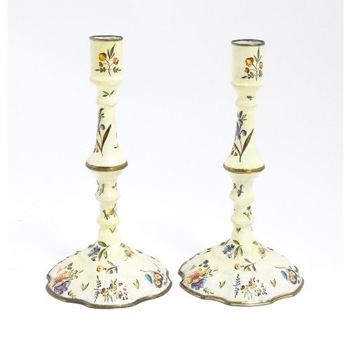 1088 - Two Bilston / Battersea enamel candlesticks with knopped columns and domed bases with hand painted f... 