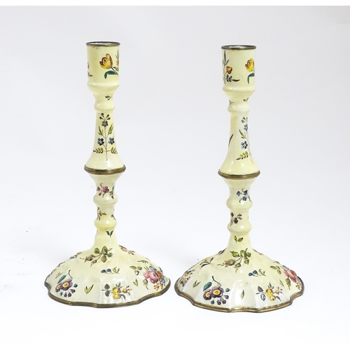 1088 - Two Bilston / Battersea enamel candlesticks with knopped columns and domed bases with hand painted f... 