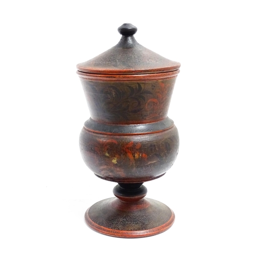 1089 - A Scandinavian folk art pedestal pot and cover with turned and lacquered foliate decoration. Approx.... 