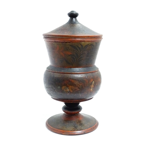 1089 - A Scandinavian folk art pedestal pot and cover with turned and lacquered foliate decoration. Approx.... 