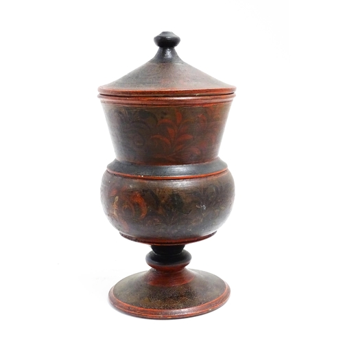 1089 - A Scandinavian folk art pedestal pot and cover with turned and lacquered foliate decoration. Approx.... 