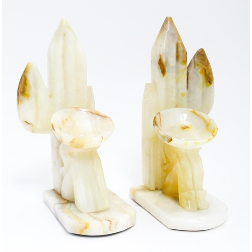 1100 - A pair of 20thC carved alabaster bookends modelled as a seated Mexican wearing a sombrero  with a ca... 