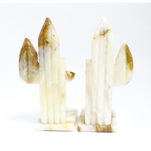 1100 - A pair of 20thC carved alabaster bookends modelled as a seated Mexican wearing a sombrero  with a ca... 