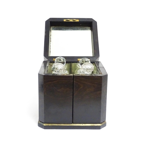 1101 - A Victorian ebonised dressing table cabinet opening to reveal a mirrored interior with four associat... 