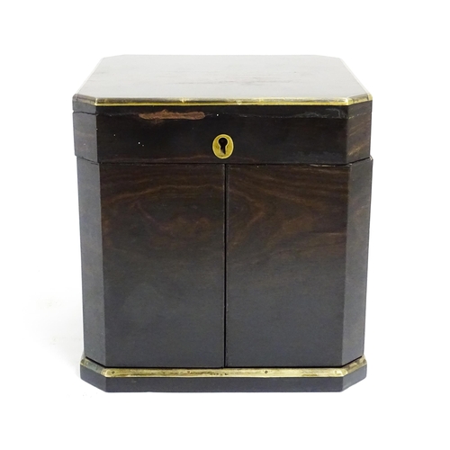 1101 - A Victorian ebonised dressing table cabinet opening to reveal a mirrored interior with four associat... 