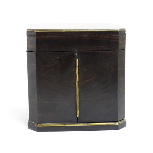 1101 - A Victorian ebonised dressing table cabinet opening to reveal a mirrored interior with four associat... 