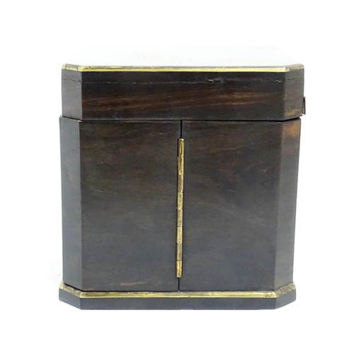 1101 - A Victorian ebonised dressing table cabinet opening to reveal a mirrored interior with four associat... 