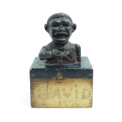 1113 - A cast iron novelty money box / piggy bank titled 'Little Joe Bank'. Mounted on a wooden box. Approx... 