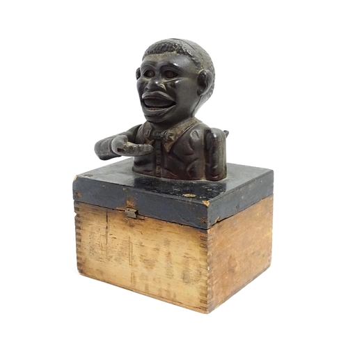 1113 - A cast iron novelty money box / piggy bank titled 'Little Joe Bank'. Mounted on a wooden box. Approx... 