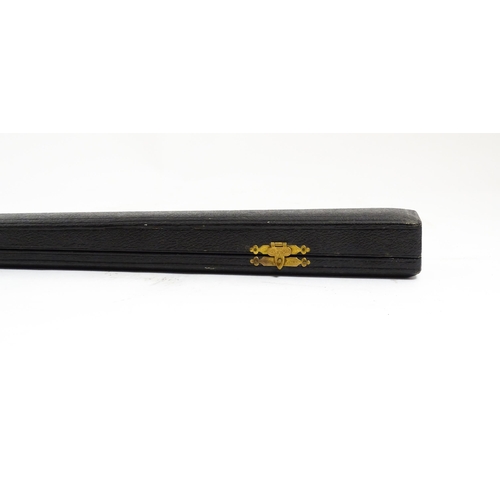 1118 - An early 20thC ebonised conductor's baton of tapering form with silver mounts engraved with foliate ... 