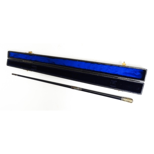 1118 - An early 20thC ebonised conductor's baton of tapering form with silver mounts engraved with foliate ... 