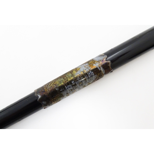 1118 - An early 20thC ebonised conductor's baton of tapering form with silver mounts engraved with foliate ... 