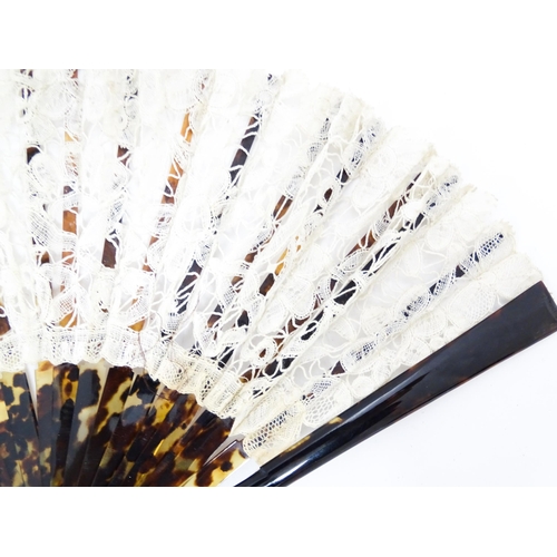 1119 - An early 20thC black feather fan with 20 faux tortoiseshell sticks. Together with another smaller ex... 