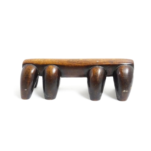 1122 - Ethnographic / Native / Tribal: A tribal carved wooden head rest with eight supports. Approx. 4 1/4