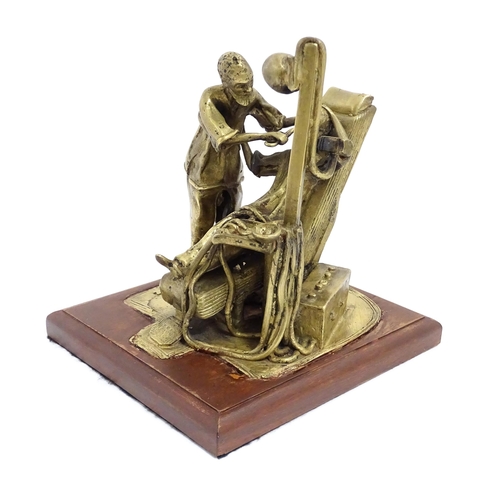 1025 - A 20thC brass sculpture depicting dentist and patient, with a wooden base. Approx. 8 3/4