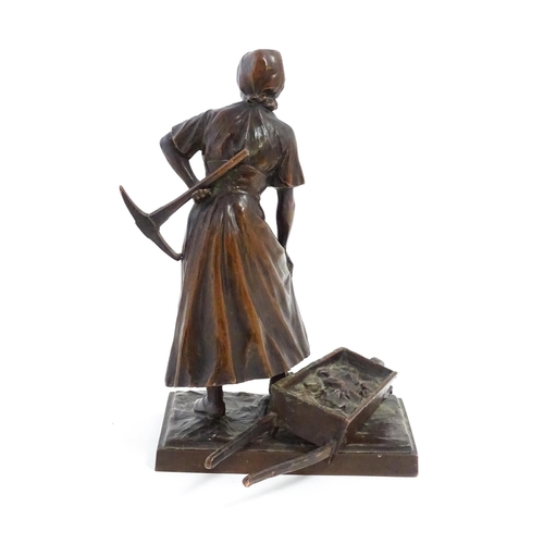 1029 - A 20thC cast sculpture depicting a female miner with an axe and a wheelbarrow of coal. Numbered 6129... 