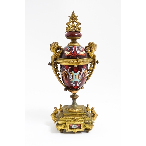 1033 - A late 19th / early 20thC single garniture of urn form with painted detail and gilt figural and dolp... 