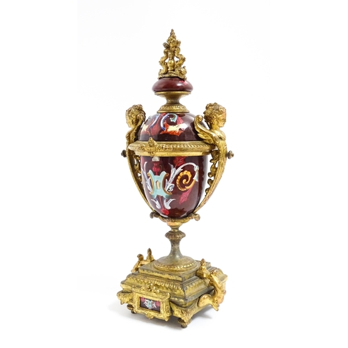 1033 - A late 19th / early 20thC single garniture of urn form with painted detail and gilt figural and dolp... 