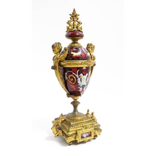 1033 - A late 19th / early 20thC single garniture of urn form with painted detail and gilt figural and dolp... 