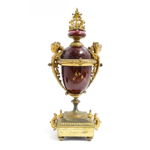 1033 - A late 19th / early 20thC single garniture of urn form with painted detail and gilt figural and dolp... 