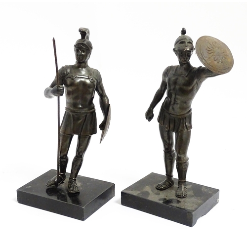 1035 - Two 20thC cast sculptures depicting centurion soldiers with helmets and shields. Approx. 7