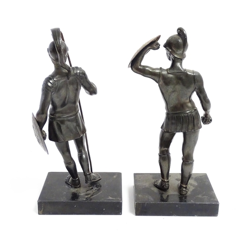 1035 - Two 20thC cast sculptures depicting centurion soldiers with helmets and shields. Approx. 7