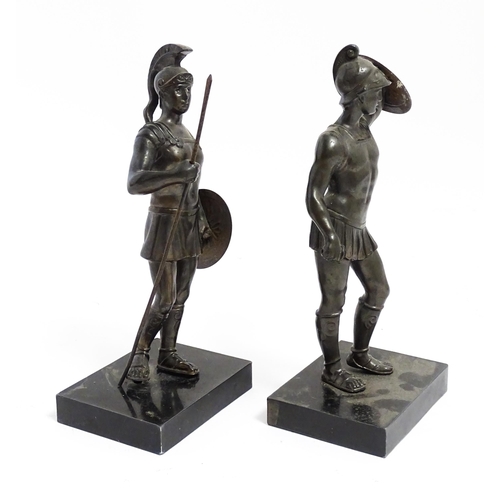 1035 - Two 20thC cast sculptures depicting centurion soldiers with helmets and shields. Approx. 7