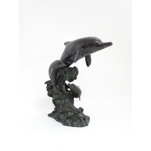 1048 - A bronze sculpture / water feature modelled as three dolphins leaping from a wave. Approx. 16 1/4