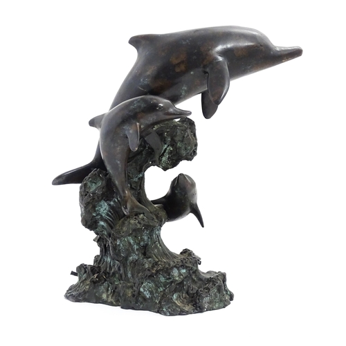 1048 - A bronze sculpture / water feature modelled as three dolphins leaping from a wave. Approx. 16 1/4