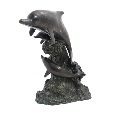 1048 - A bronze sculpture / water feature modelled as three dolphins leaping from a wave. Approx. 16 1/4