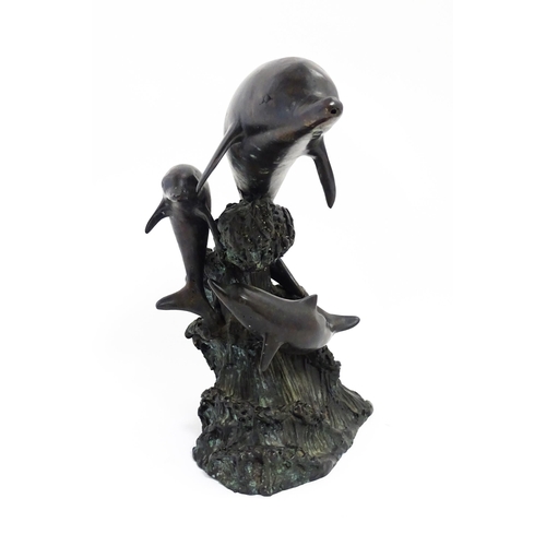 1048 - A bronze sculpture / water feature modelled as three dolphins leaping from a wave. Approx. 16 1/4