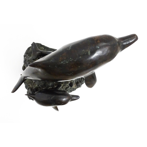 1048 - A bronze sculpture / water feature modelled as three dolphins leaping from a wave. Approx. 16 1/4